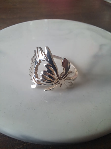 Silver protea flower ring on marble display